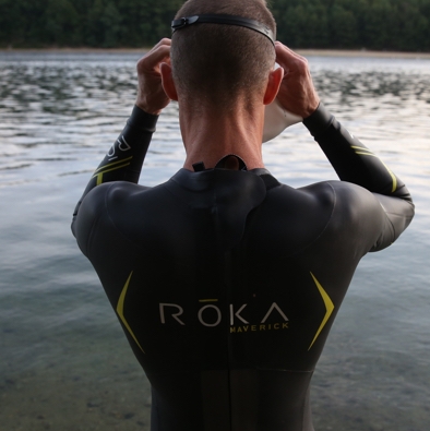 man in wetsuit about to swim